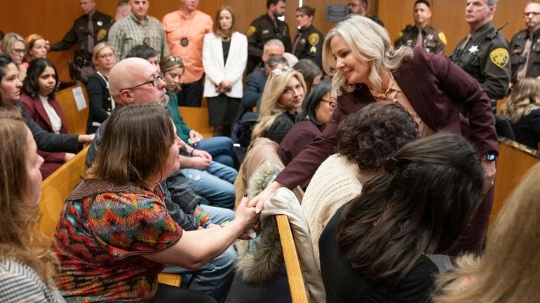 Oakland County Prosecutor Karen McDonald, right, shakes hands with Oxford...