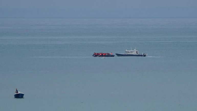 A boat thought to be with migrants is escorted by...