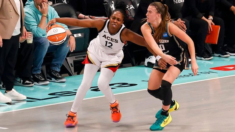 Chelsea Gray #12 of the Las Vegas Aces dribbles against...