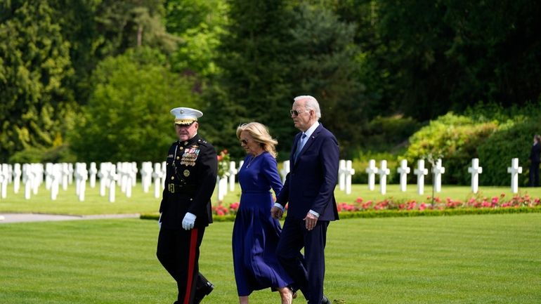 U.S. President Joe Biden and First Lady Jill Biden walk...