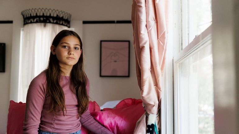 Scarlett Goddard Strahan, 11, poses for a portrait at her...