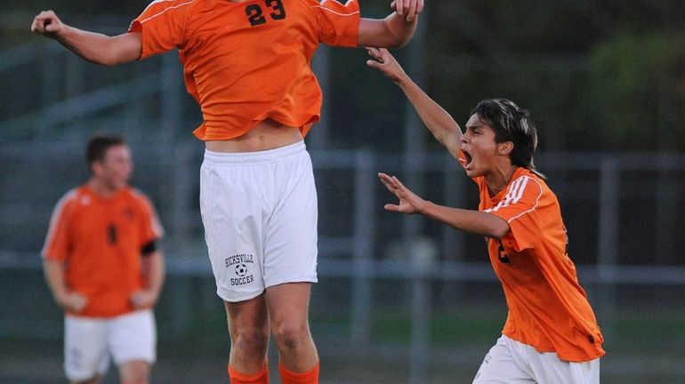 Hicksville's Ryan Dilorenzo, left, and Branden Mueza celebrate after their...