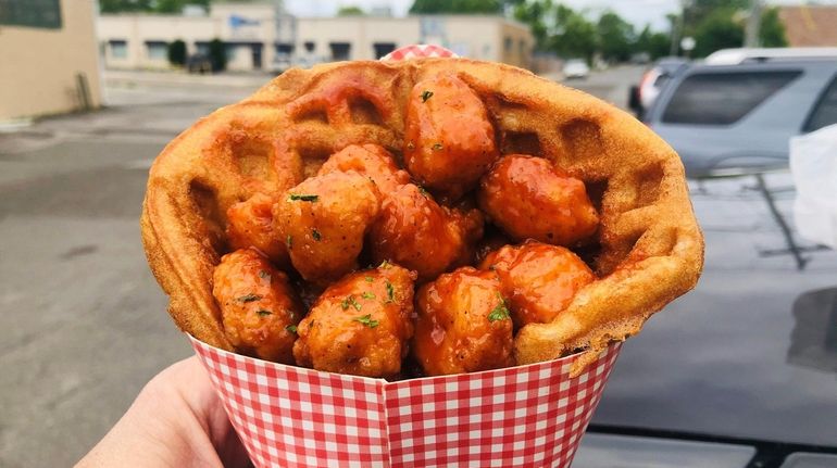 Popcorn chicken with barbecue sauce in a waffle cone at...