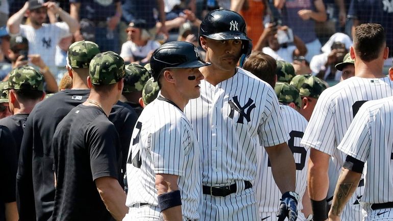 Giancarlo Stanton #27 of the Yankees holds back teammate Josh Donaldson...