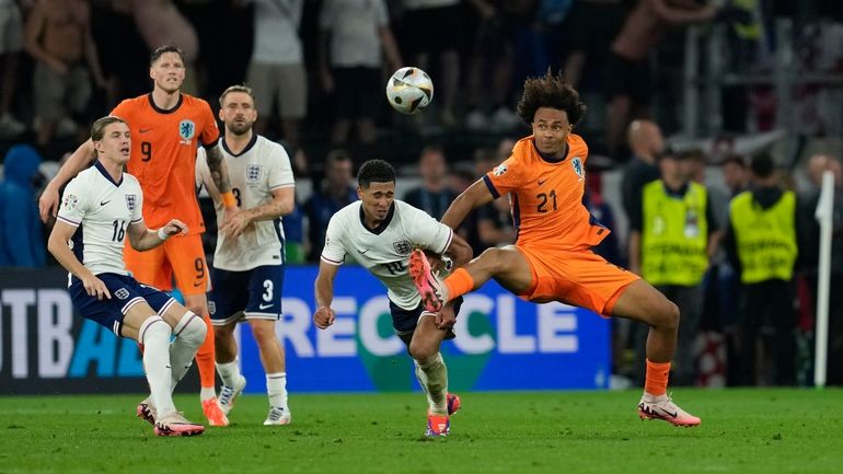 Netherlands's Joshua Zirkzee right, challenges England's Jude Bellingham during a...