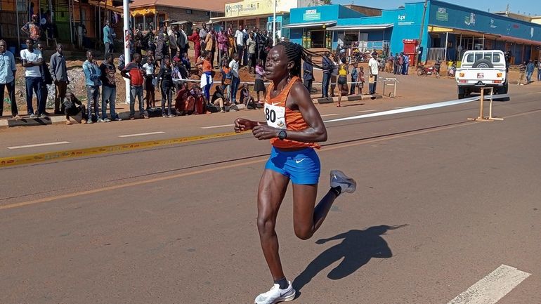 FILE -Rebecca Cheptegei, competes at the Discovery 10km road race...