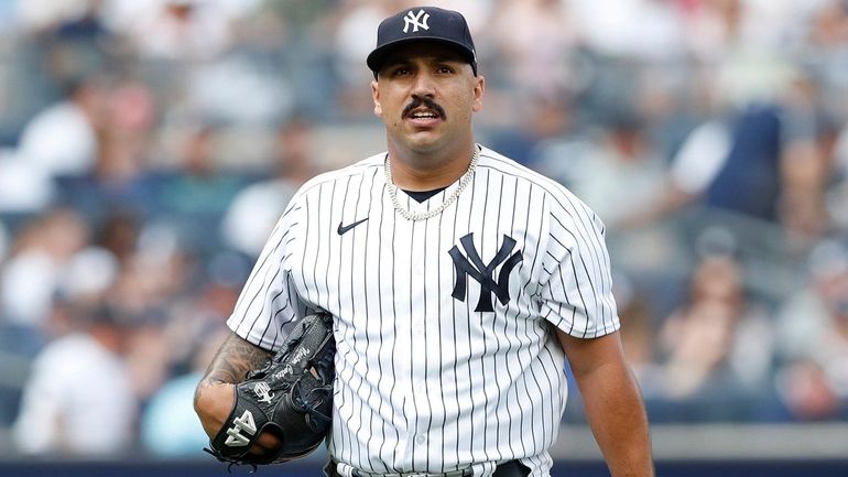 Yankees starting pitcher Nestor Cortes goes to the dugout n...