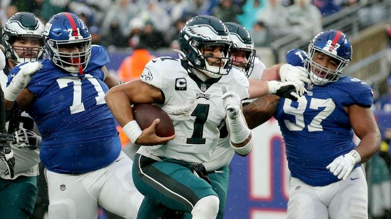 Eagles quarterback Jalen Hurts runs for a touchdown against the Giants...