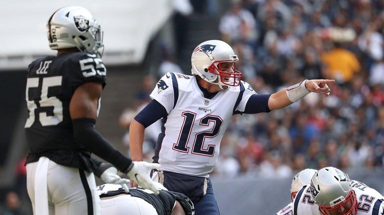 Tom Brady of the New England Patriots directs the offense...