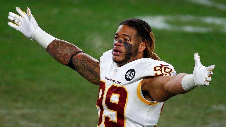 Landover, Maryland, USA. November 8, 2020: Washington Football Team  defensive end Chase Young (99) attempts to get the 3000 fans in attendance  to their feet on third down during the NFL Game