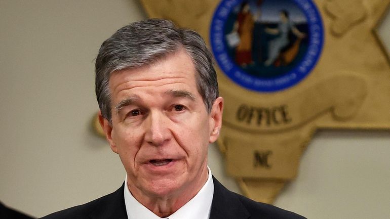 North Carolina Gov. Roy Cooper speaks at a news conference...