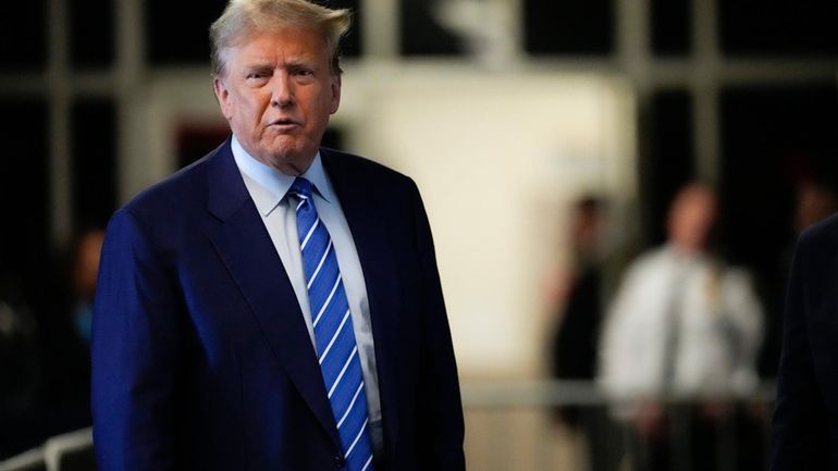 Former President Donald Trump speaks before entering the courtroom at...