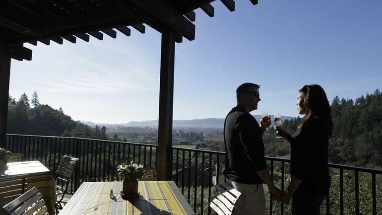 A couple drinks sparkling wine while looking at the view...