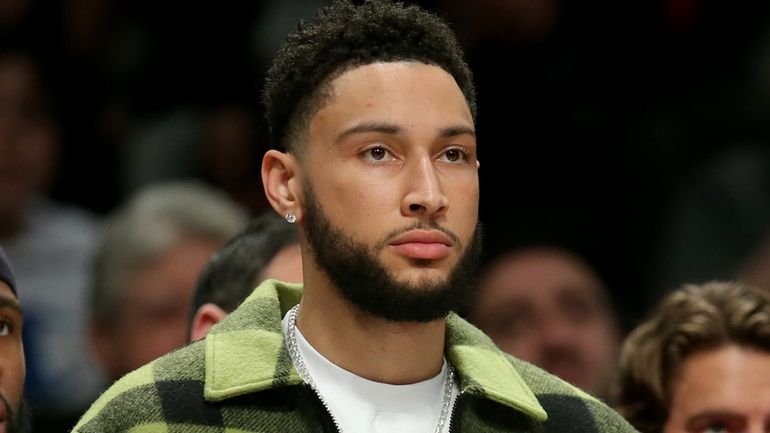 Injured Nets guard Ben Simmons watches from the bench during...