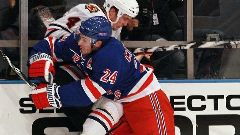 The Rangers' Ryan Callahan checks Chicago's Niklas Hjalmarsson during the...