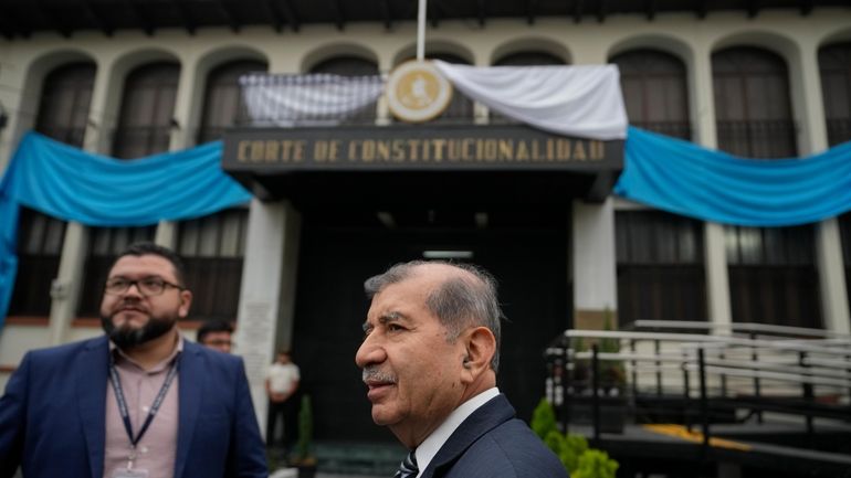 Supreme Electoral Tribunal's Mynor Franco, center, arrives to the Constitutional...