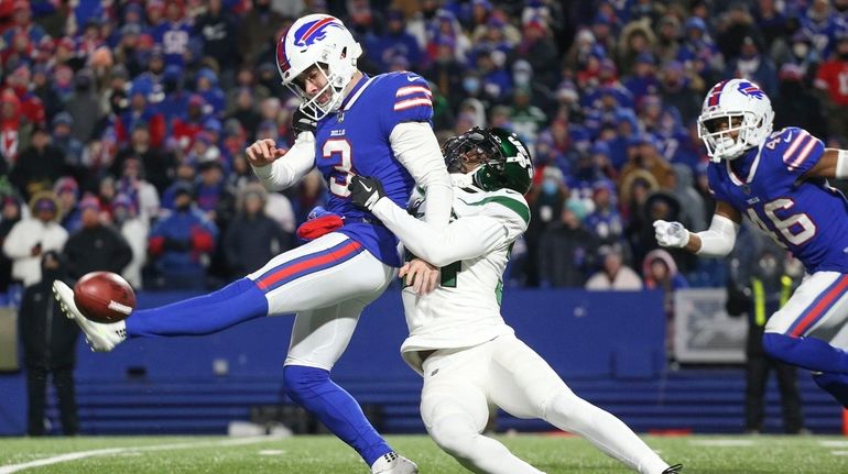 Buffalo Bills punter Matt Haack, left, attempts to punt while...