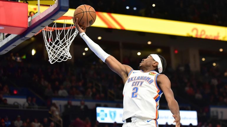 Oklahoma City Thunder guard Shai Gilgeous-Alexander goes up for a...