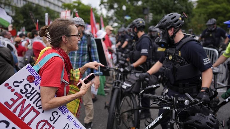 United States Capitol Police stand near protestors, Wednesday, July 24,...