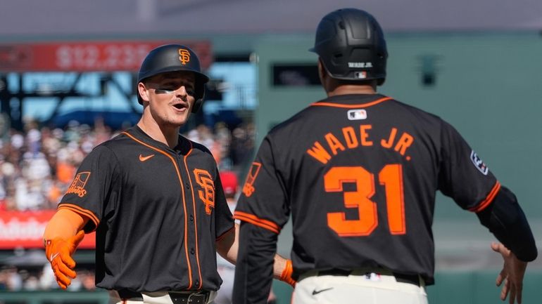 San Francisco Giants' Matt Chapman, left, celebrates with LaMonte Wade...