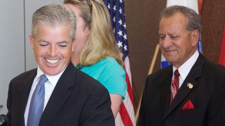 Suffolk County Executive Steve Bellone, left, acknowledges master planner Lee...