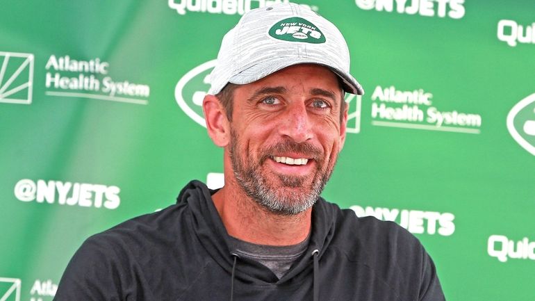 Jets QB Aaron Rodgers speaks during training camp at the team's training...