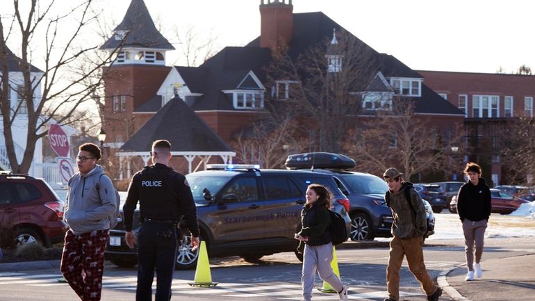 Students are released from school, under watch by local police,...