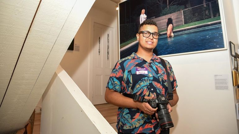 Artist Jeremy Dennis in front of his piece, "I Could...