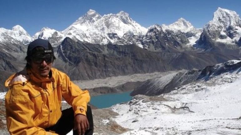 Passang Sherpa, a former mountain guide, with Mount Everest in...