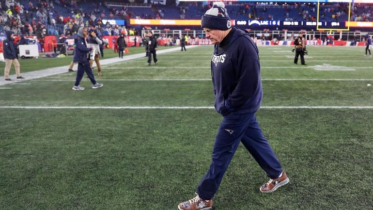 Patriots head coach Bill Belichick walks off the field after...