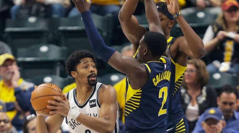 Nets guard Spencer Dinwiddie looks to pass around Pacers guard...