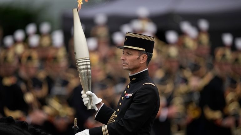 Col. Thibault Vallette, of the Cadre Noir de Saumur, carries...