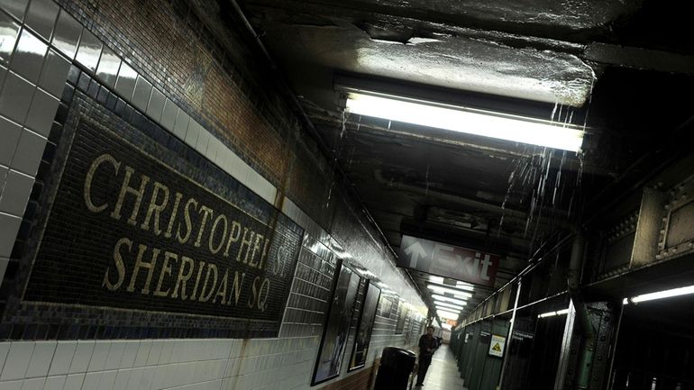 Rainwater seeps down into the Christopher Street-Sheridan Square subway station,...