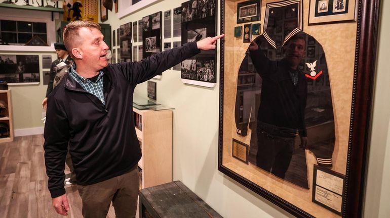 Curator and U.S. Army veteran Richard Acritelli points to a...