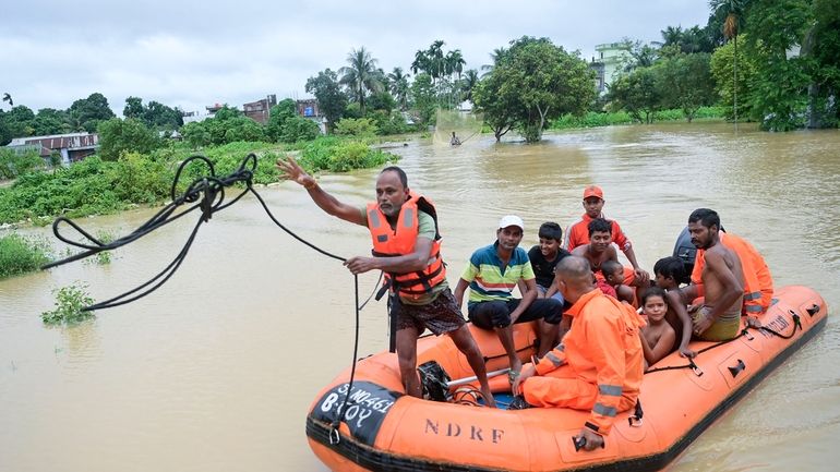 A team from the National Disaster Response Force (NDRF) transports...