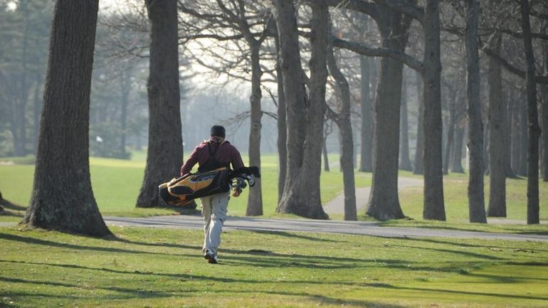 A golfer takes advantage of the beautiful day at Bethpage...