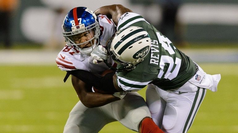 New York Jets cornerback Darrelle Revis (24) tackles New York...