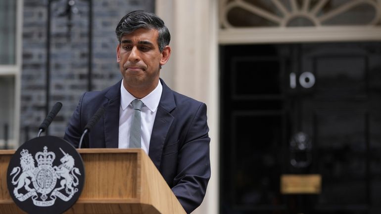 Britain's outgoing Conservative Party Prime Minister Rishi Sunak looks down...