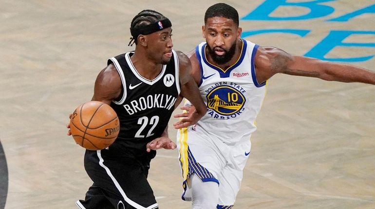 Nets guard Caris LeVert (22) drives around Golden State guard...