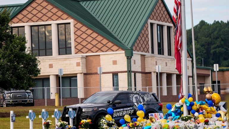 A memorial is seen at Apalachee High School after the...