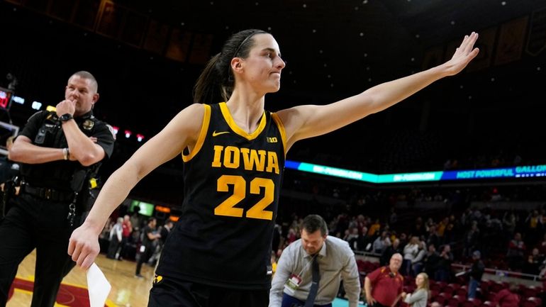 Iowa guard Caitlin Clark (22) walks off the court after...