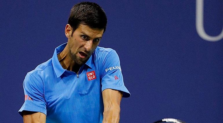 Novak Djokovic hits the backhand return against Jerzy Janowcz on...