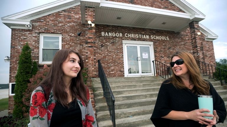 Olivia Carson, then a 15-year-old sophomore, of Glenburn, Maine, left,...