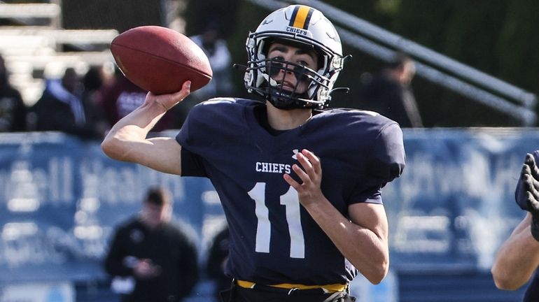 Massapequa quarterback Joey Diesso throws a short pass during the...