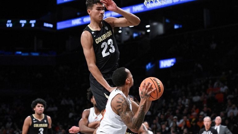 Miami guard Matthew Cleveland looks to shoot the ball while...