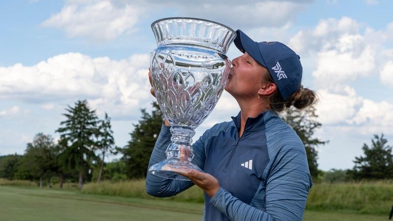 Linnea Strom, of Sweden, kisses the trophy following the final...