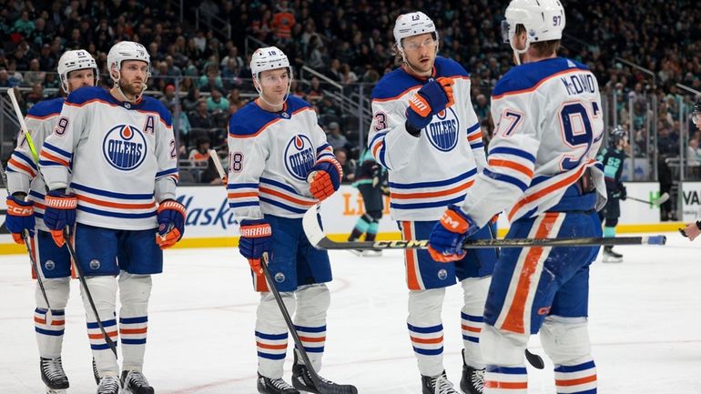 Edmonton Oilers players center Connor McDavid (97), center Mattias Janmark...