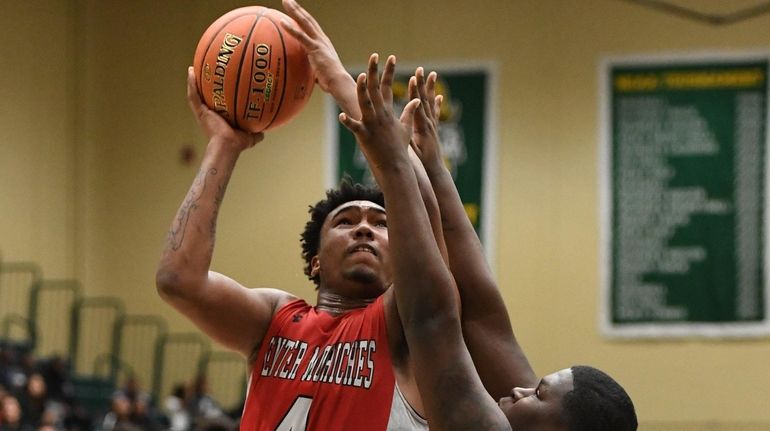 Center Moriches' Micah Snowden shoots against Wyandanch's Shykim Rich during the Suffolk...