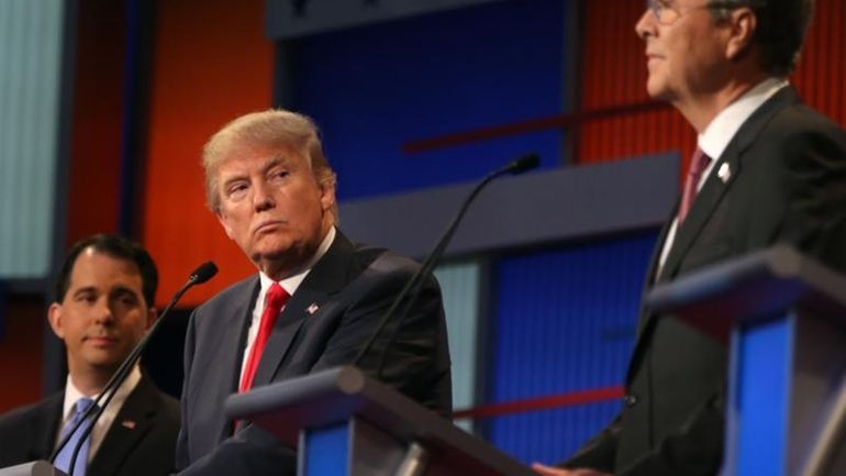 Republican presidential candidate Donald Trump looks toward Jeb Bush, right,...