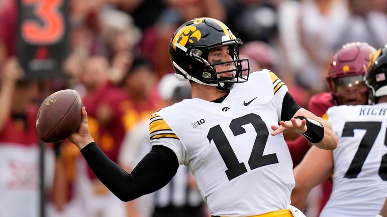 Iowa quarterback Cade McNamara (12) throws a pass during the...